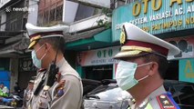 Indonesian police distribute free masks to residents to prevent spread of coronavirus
