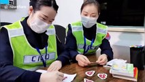 Toll gate staff on Chinese highway draw smiles on their face masks to appear friendly