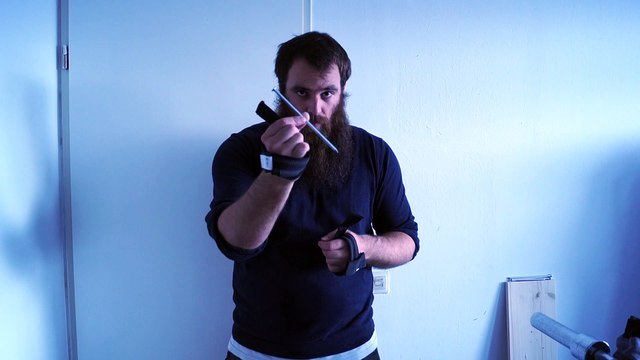 Old time strongman JK bending a 0.6 x 18 cm nail with straps only 1