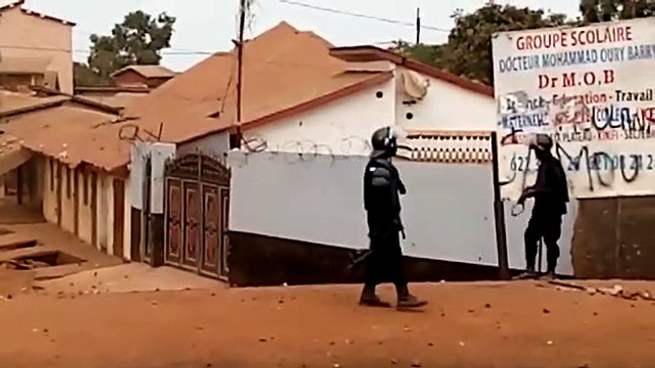 Un policier fait usage d'un lance-pierre contre des manifestants à Wanindara