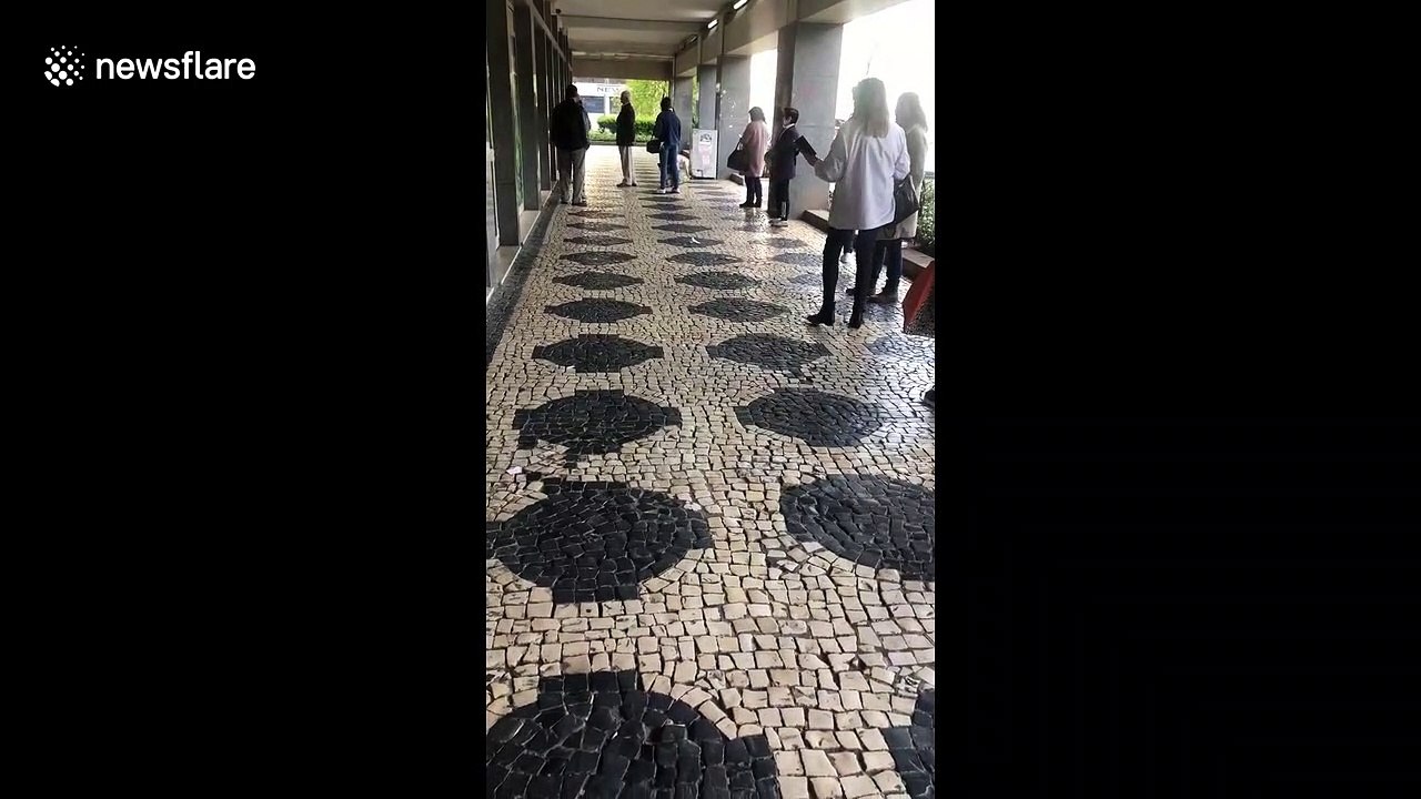 Queues form on Portuguese highstreet as only 100 customers allowed in at once during COVID-19 pandemic