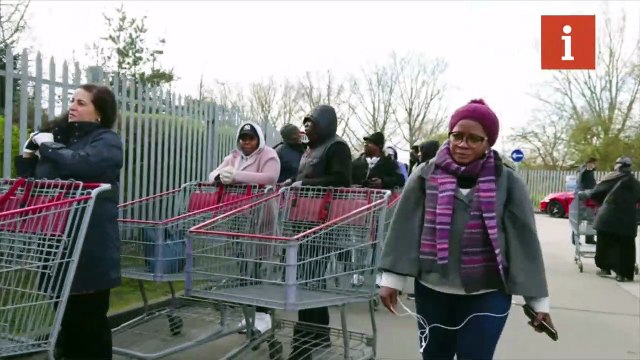 People queue outside Costco Wholesale store in Chingford, London as coronavirus prompts fears of lockdown