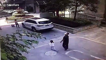 Man and girl narrowly avoid being crushed by glass window that fell from residential building in China