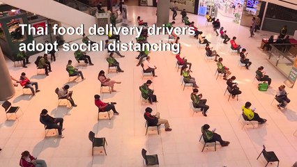 Thai food delivery drivers adopt social distancing