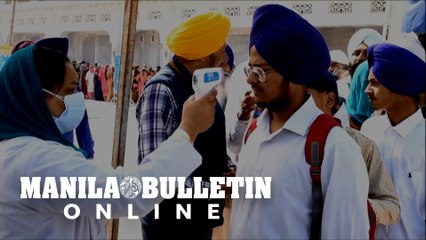 Temperature checks and hand sanitizer at India's Golden Temple