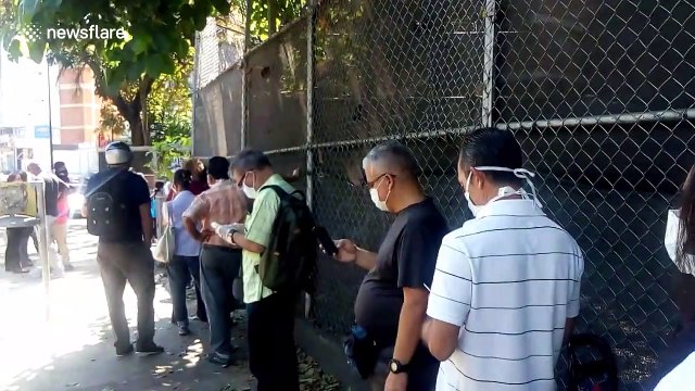 Venezuelans in face masks seen queuing to buy food during COVID-19 lockdown