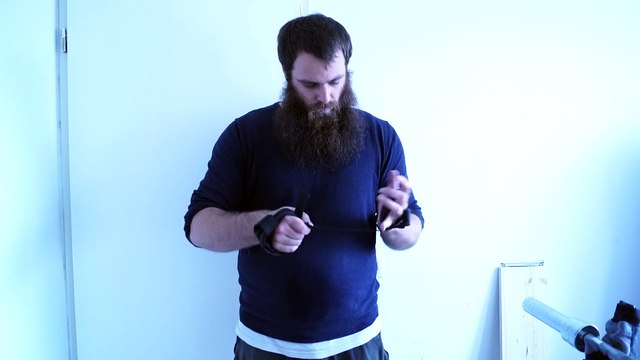 Old time strongman JK bending a 0.6 x 18 cm nail with straps only 2