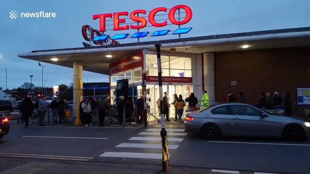 Shoppers queue outside Tesco in London at 6 a.m.