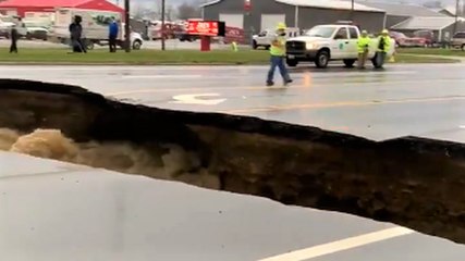 Road washed out as floodwaters rage