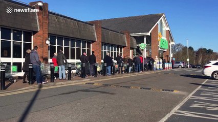 UK shoppers queue around Asda car park despite pleas not to "panic buy"