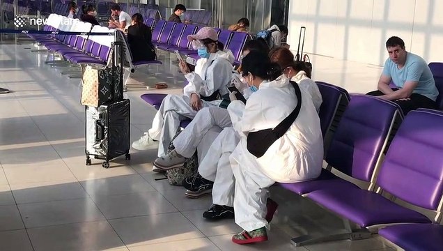 Tourists seen wearing hazmat suits and googles at Thai airport