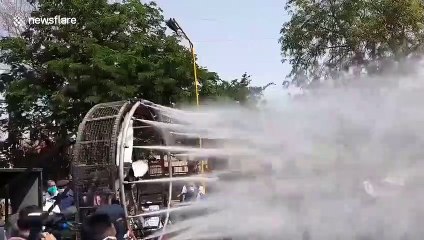 Indian officials use high-pressure water jets attached to fan to spray disinfectant