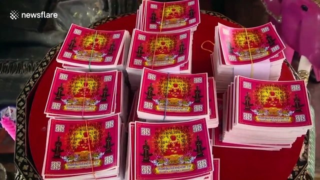 Thai Buddhist monks give lucky charms to devotees to protect them from Covid-19