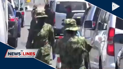 Soldier manning checkpoint under monitoring for CoVID-19 symptoms