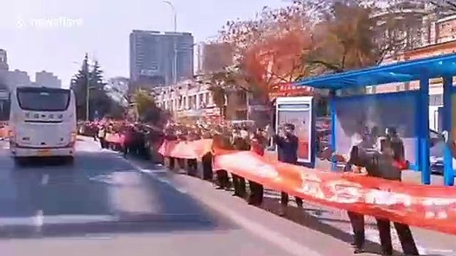 Chinese man bows down to thank coronavirus medical workers who saved 11 infected family members