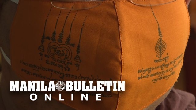 Thai monks make talisman face masks from recycled plastic