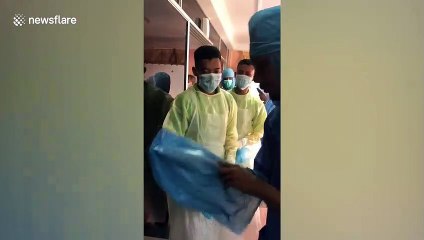 Malaysian medical staff use plastic bags as protection due to shortage of supplies