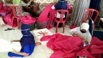 Indonesian residents sew together protective clothing for health workers combating COVID-19 pandemic