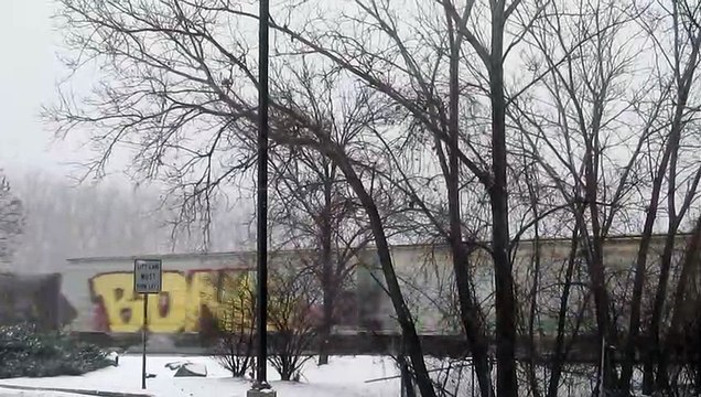 Short CSX Mixed Freight Train Passes by Destiny USA in a SnowStorm
