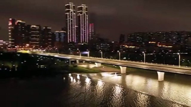 Night rider: Empty streets under glistening evening lights in Wuhan