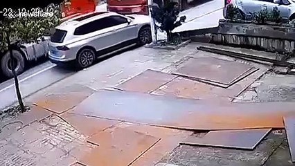 Bricks falling from transport truck after collision flatten car in south China