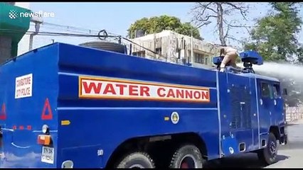 Authorities in southern India use water cannons to disinfect roads during coronavirus outbreak