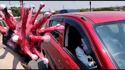 Indian police officer wears coronavirus helmet to encourage social distancing