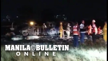 Fire fighters extinguish the flames of Lion Air plane that crashed at NAIA