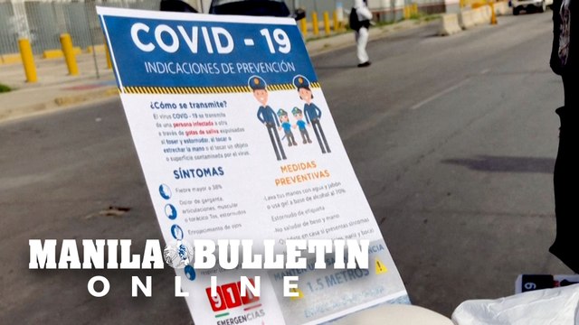 Mexican authorities give COVID-19 pamphlets to people entering the country