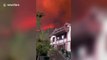 Thick smoke caused by huge mountain fire turns sky orange in China