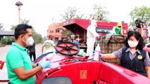 Thai farmers use tractors to spray streets with sanitising liquid during coronavirus pandemic