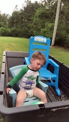 Tuckered Toddler Nods Off during Lawnmower Ride