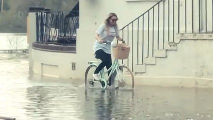 A little flooding won't stop this woman from bicycling