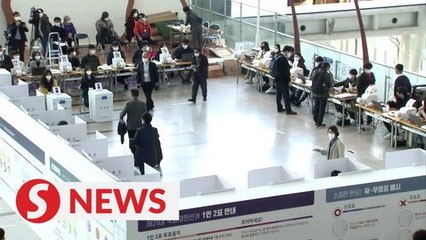 South Korea kicks off voting in masks and gloves