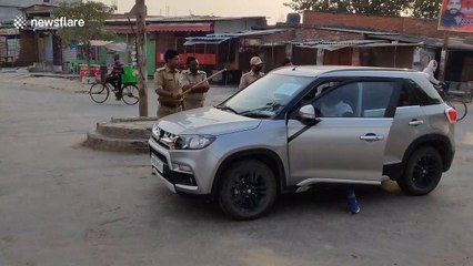 Indian police confront man flouting social distancing rules in car