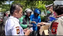 Indonesian police distribute masks and hand sanitizer