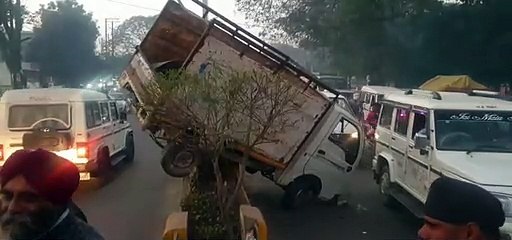 Pickup mounted on divider, driver left narrowly