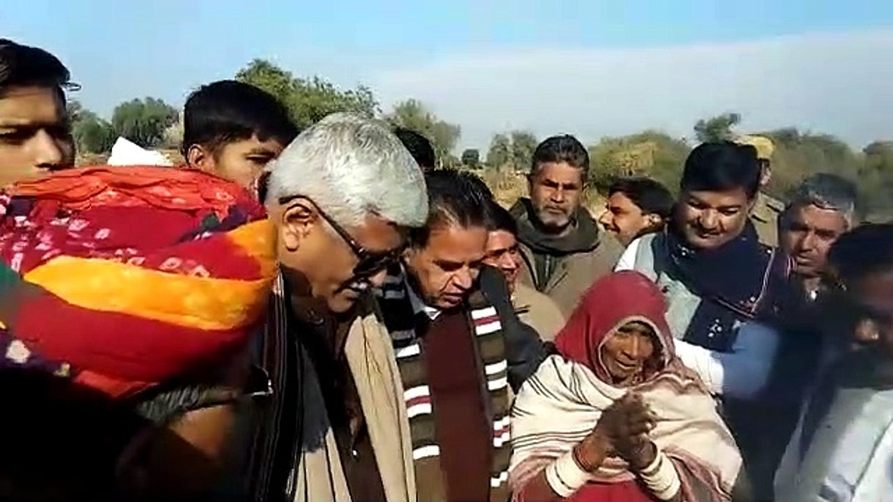 a lady playing iron tin in front of minister ga...
