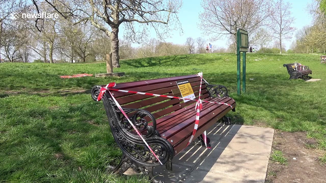 Police on patrol as Clapham Common park benches taped off by council during coronavirus lockdown