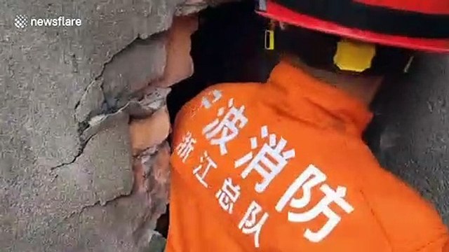 Chinese firefighters free children from narrow gap between walls after they get stuck while playing hide and seek