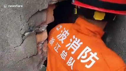 Chinese firefighters free children from narrow gap between walls after they get stuck while playing hide and seek