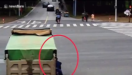 Helmet saves Chinese biker's life after his head was run over by a truck