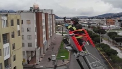 Image of the day: Firefighter plays trumpet to cheer up people during lockdown in Ecuador