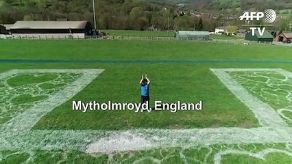 UK artist makes giant NHS logo field art in support of health workers