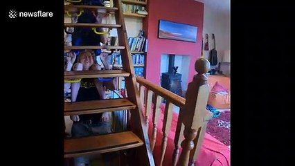 UK family perform pull-ups together on set of stairs during COVID-19 lockdown