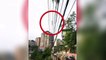 Chinese firefighters catch snake wrapped around power lines