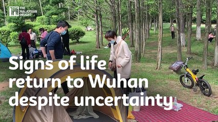 Signs of life return to Wuhan despite uncertainty