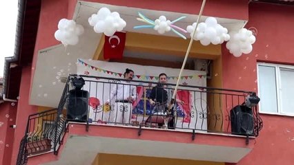 Eşiyle birlikte balkonuna kurduğu ses sistemiyle 23 Nisan'ı kutladılar