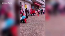 Excited Chinese student performs martial arts routine at school's gate on reopening day