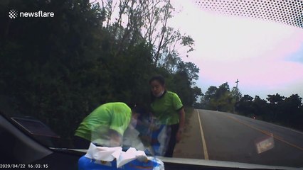 Motorcyclist wobbles and slams into the ground as car behind has to swerve to avoid him